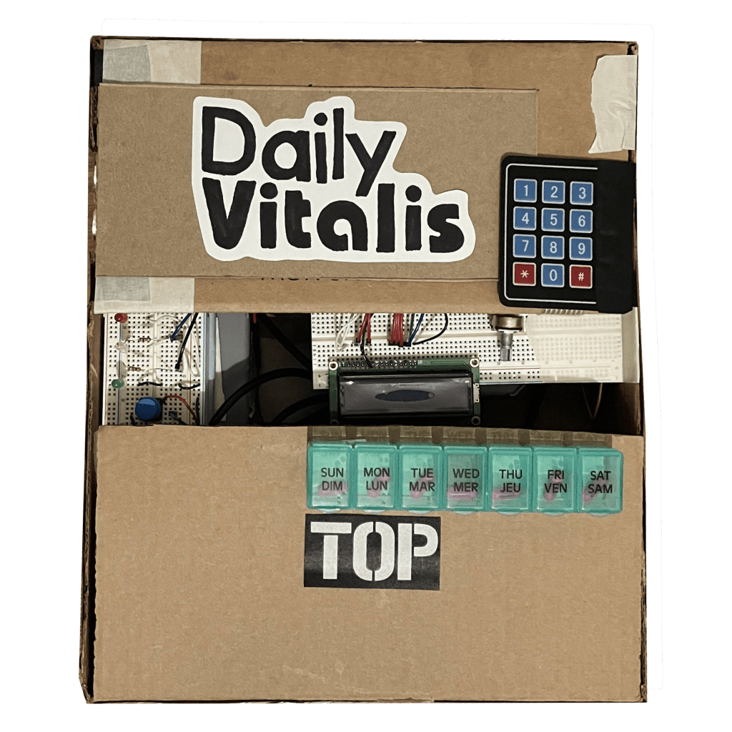 Image of cardboard box with the text 'Daily Vitalis' on the cover with a medication pill box and a keypad glued on.